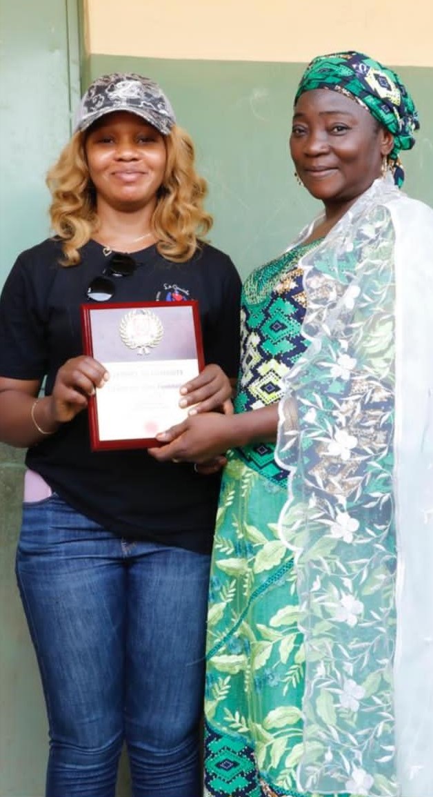 Miss Uche receiving an award